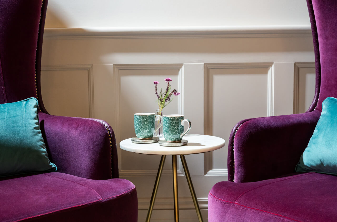 Two mugs and two sofas in the Evewell Clinic waiting room