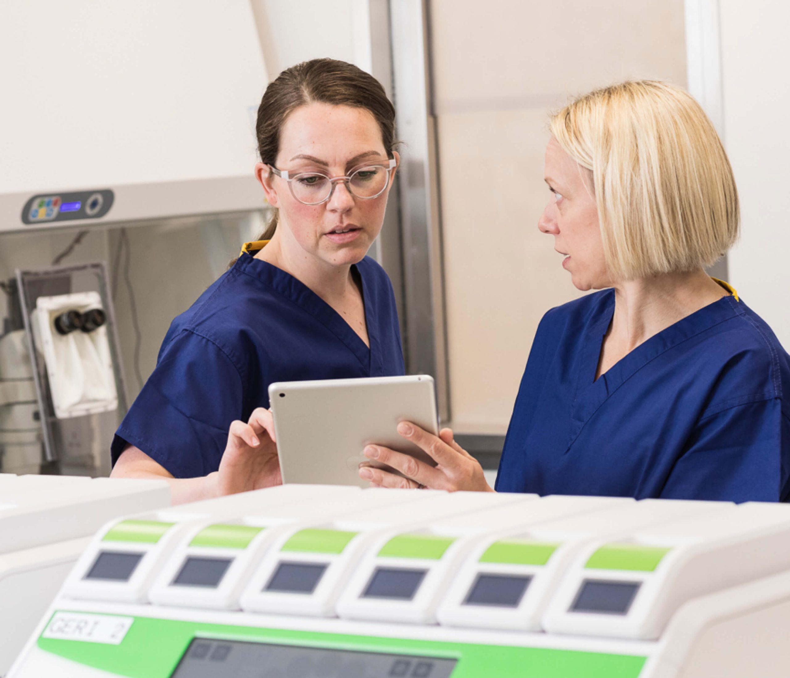 Two embryologists in the laboratory discussing fertility treatments for a patient