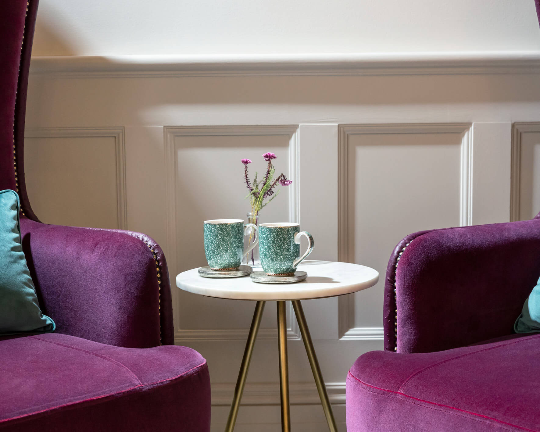 Two mugs and two sofas inside the Evewell Clinic