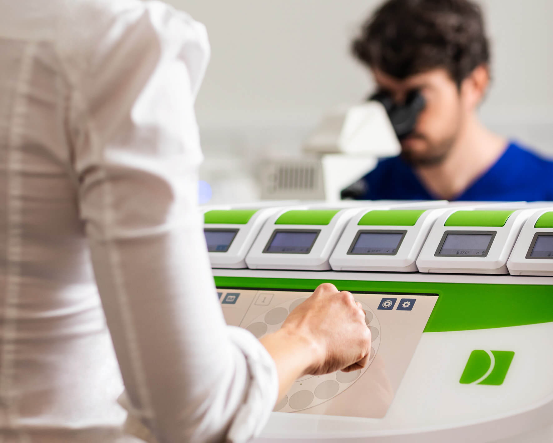 Embryologists looking at embryo samples for ICSI in the Evewell laboratory