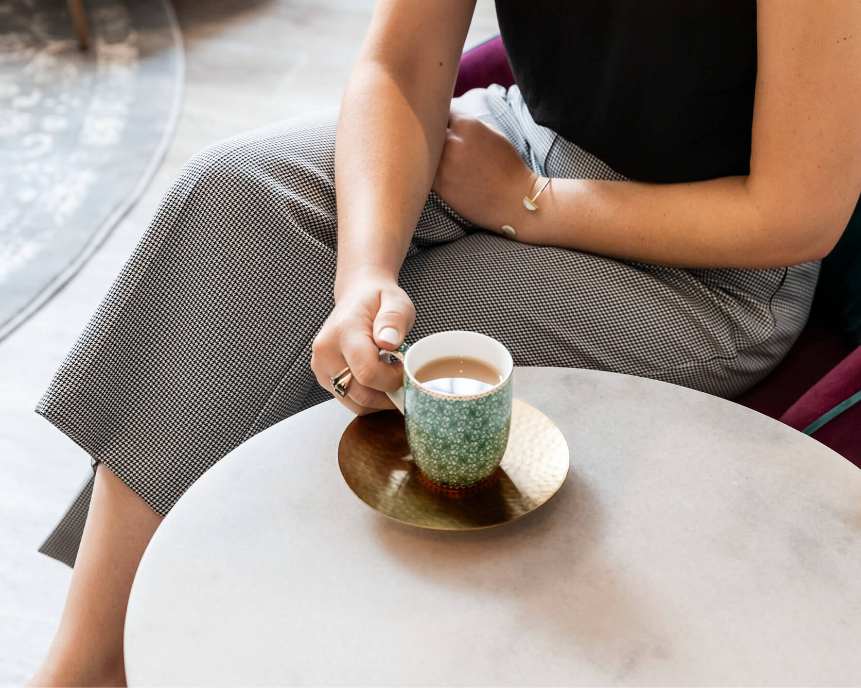 a woman sitting at a chair with a cup of tea discussing she needs help getting pregnant
