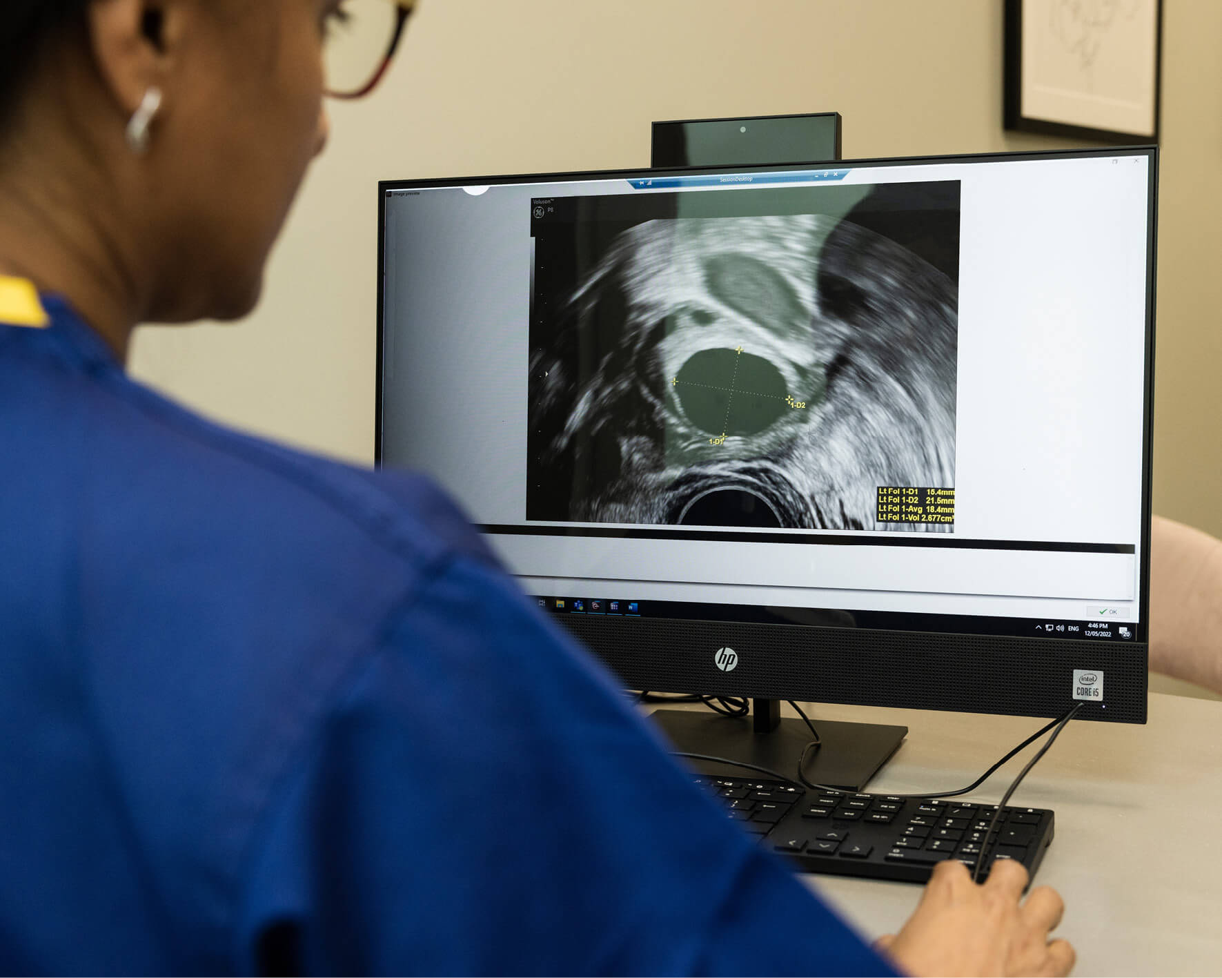 Clinician looking at an image of an ultrasound on a computer screen